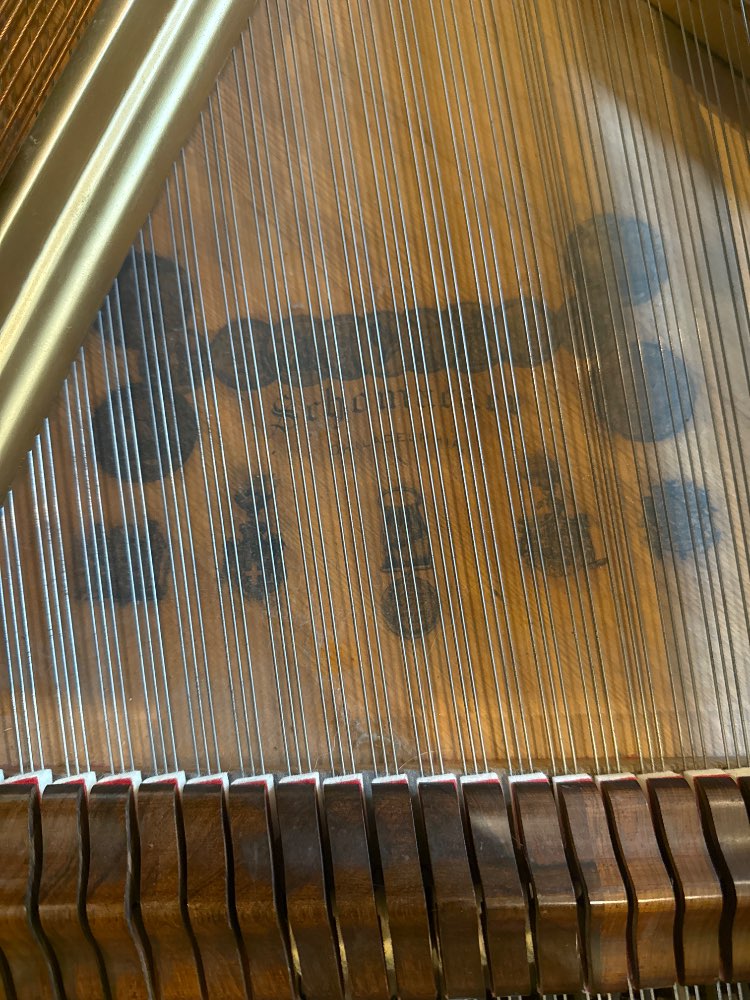 Schomacker soundboard and string detail with maker's name